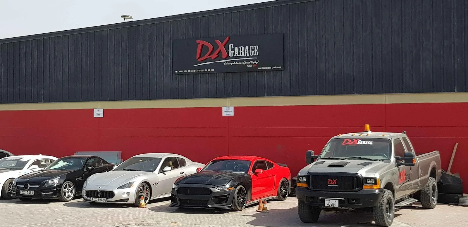 DX Garage building exterior with cars parked outside