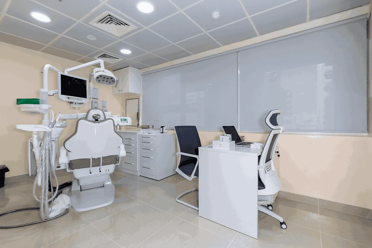 Medical clinic room with grey roller blinds