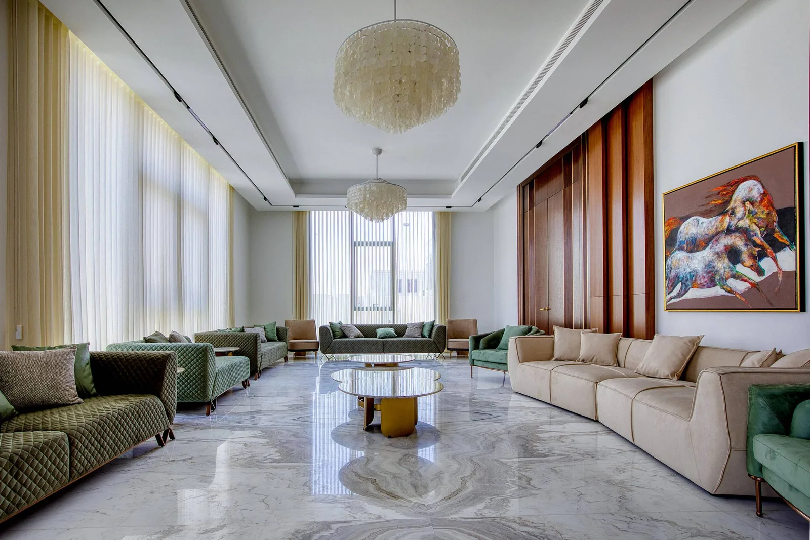A bright Dubai living room with full-height sheer curtains and a marble floor, fitted by Blindtex