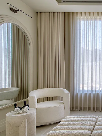 White plantation shutters behind a vase of flowers