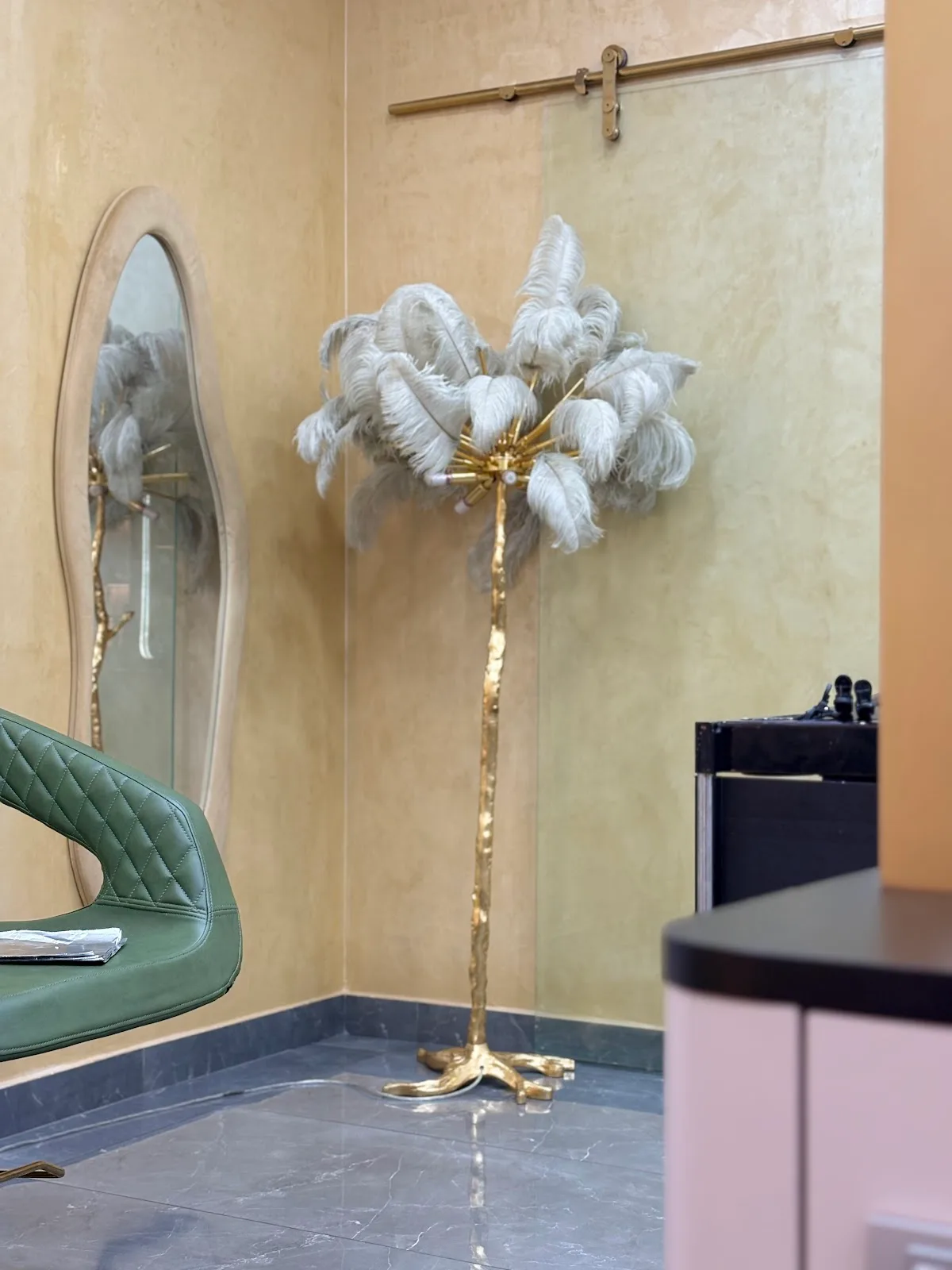 Gold feather floor lamp in a styling corner