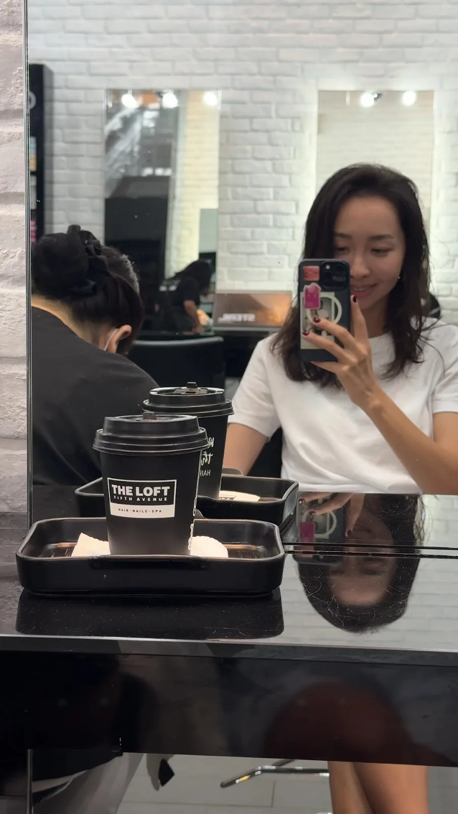 Branded The Loft Fifth Avenue coffee cups served on a tray at the styling station