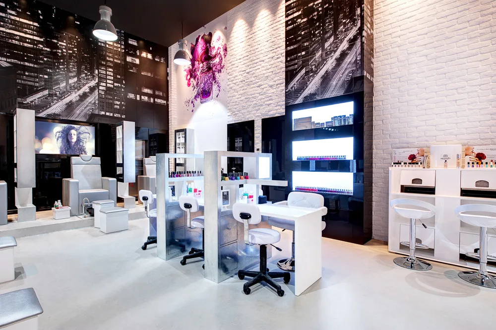 White-brick nail studio with skyline murals and manicure stations