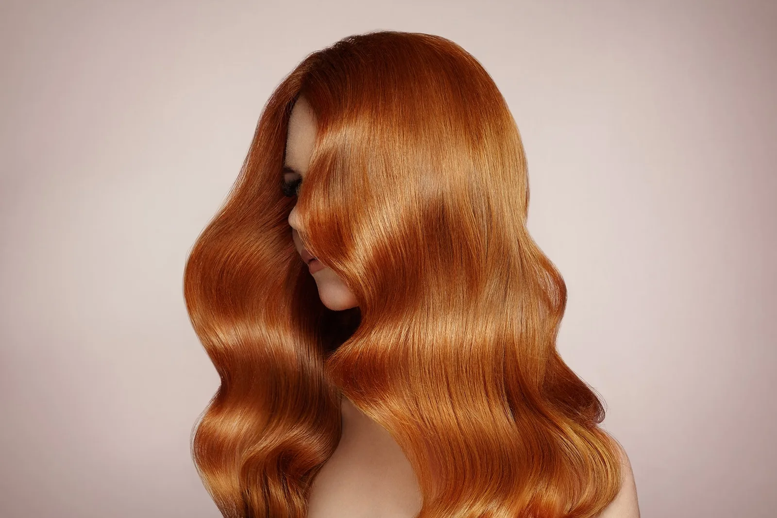 Glossy long auburn waves — hair styling at the lounge