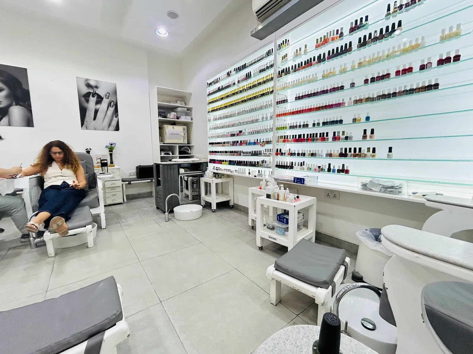 Inside the salon — nail-polish wall and pedicure stations