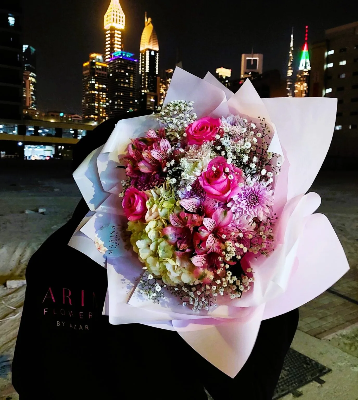 Pink rose and alstroemeria bouquet in white wrap