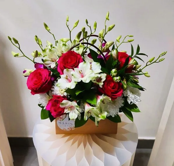 Pale blue and white bouquet against the studio wall