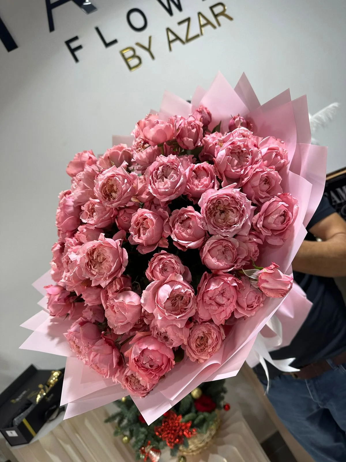 Two wrapped bouquets on the studio counter