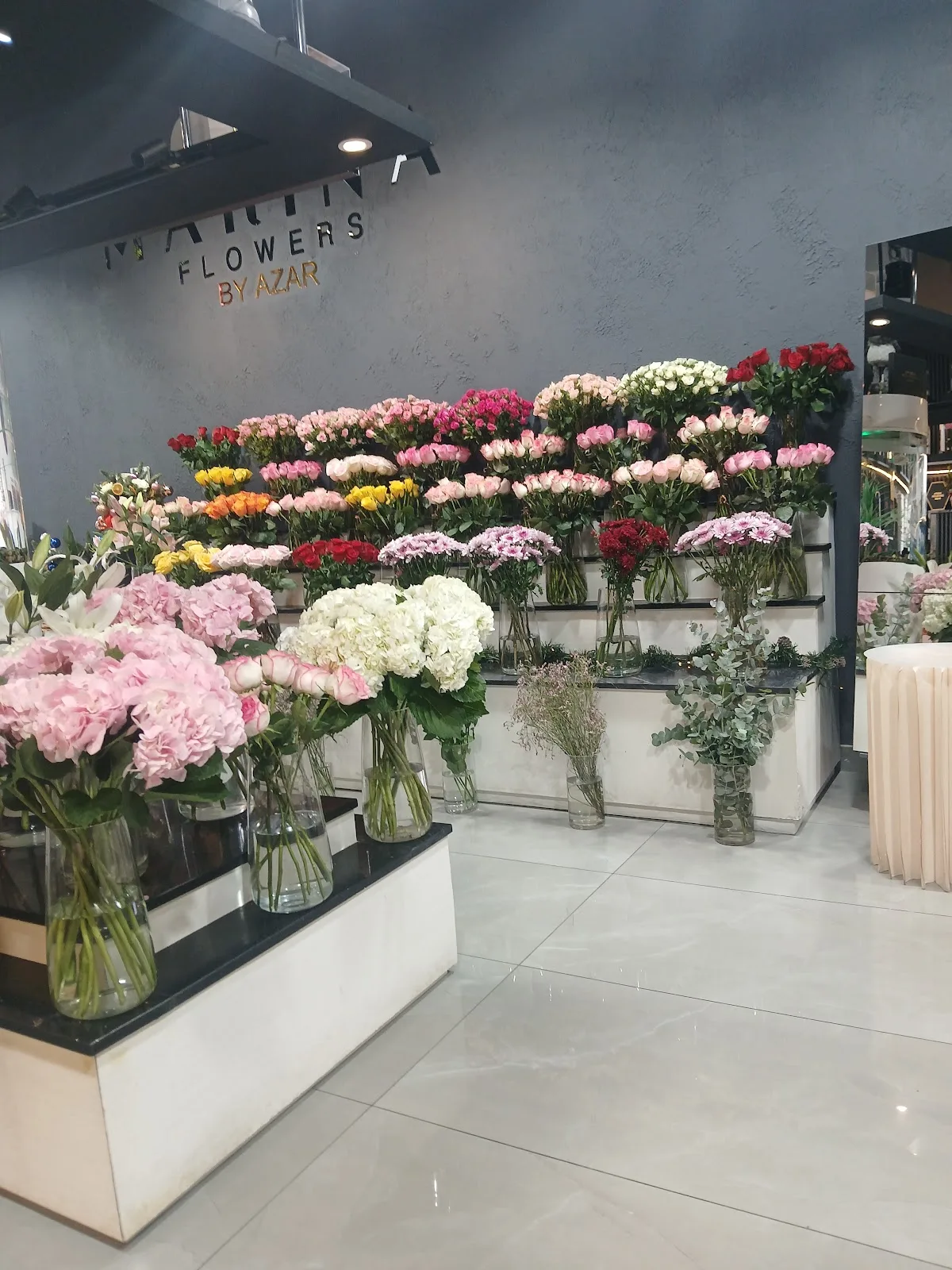 A large dome of white roses held at the studio
