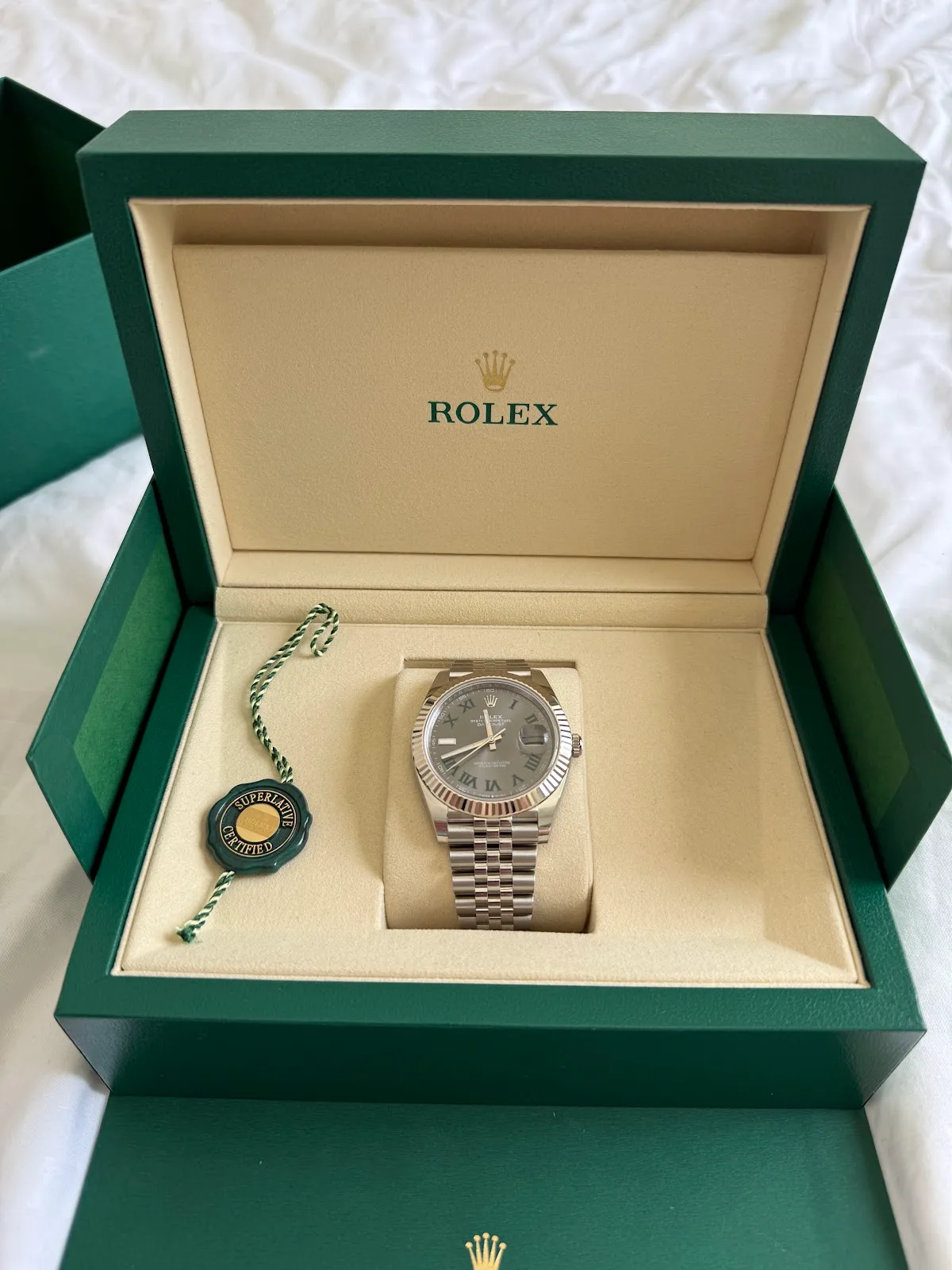 Rolex Datejust presented in an open green Rolex box