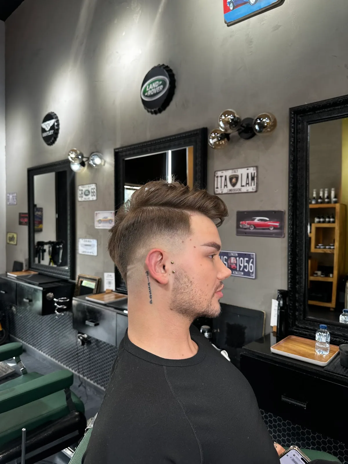 Side profile of a client with a freshly cut textured top and skin fade