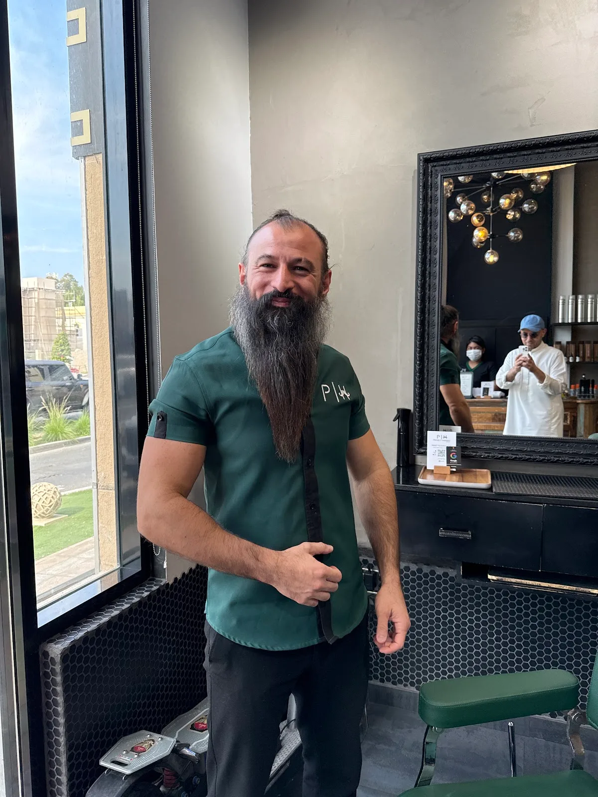 Barber and client checking the finished cut in the large framed mirror