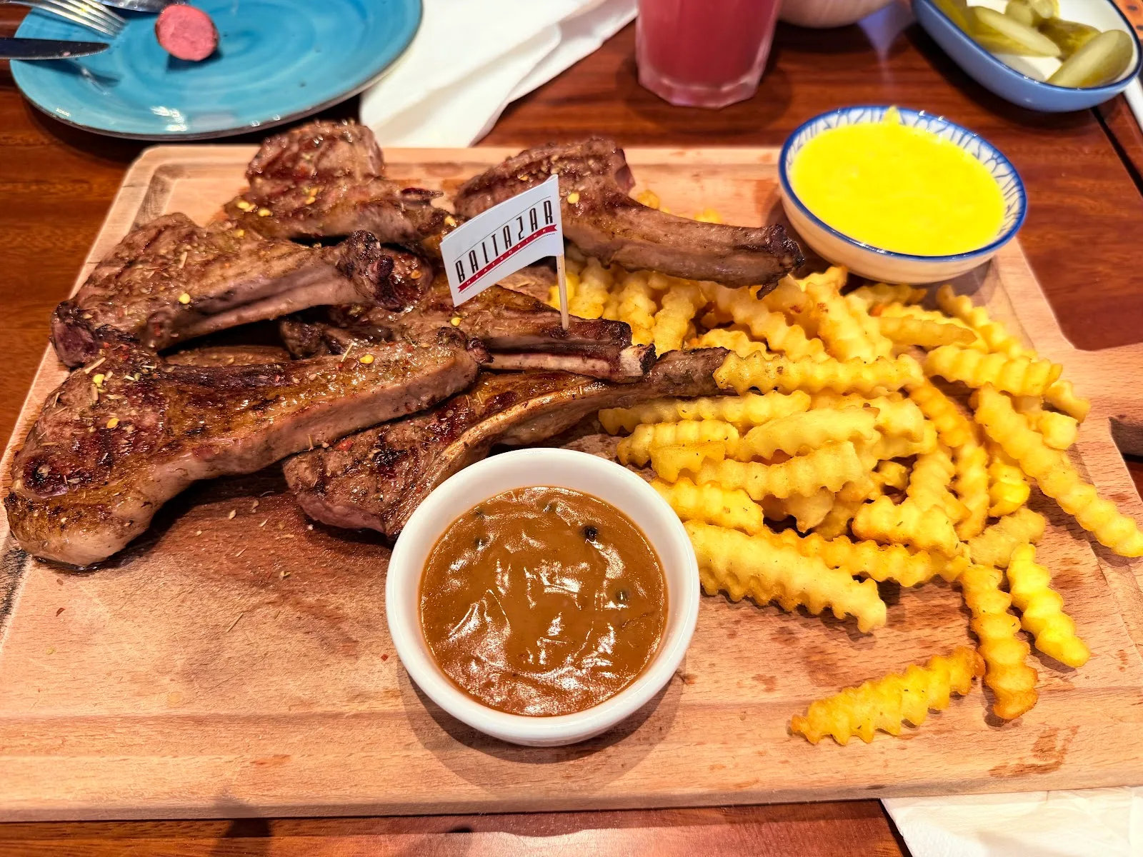 Grilled lamb chops with crinkle-cut fries and dips