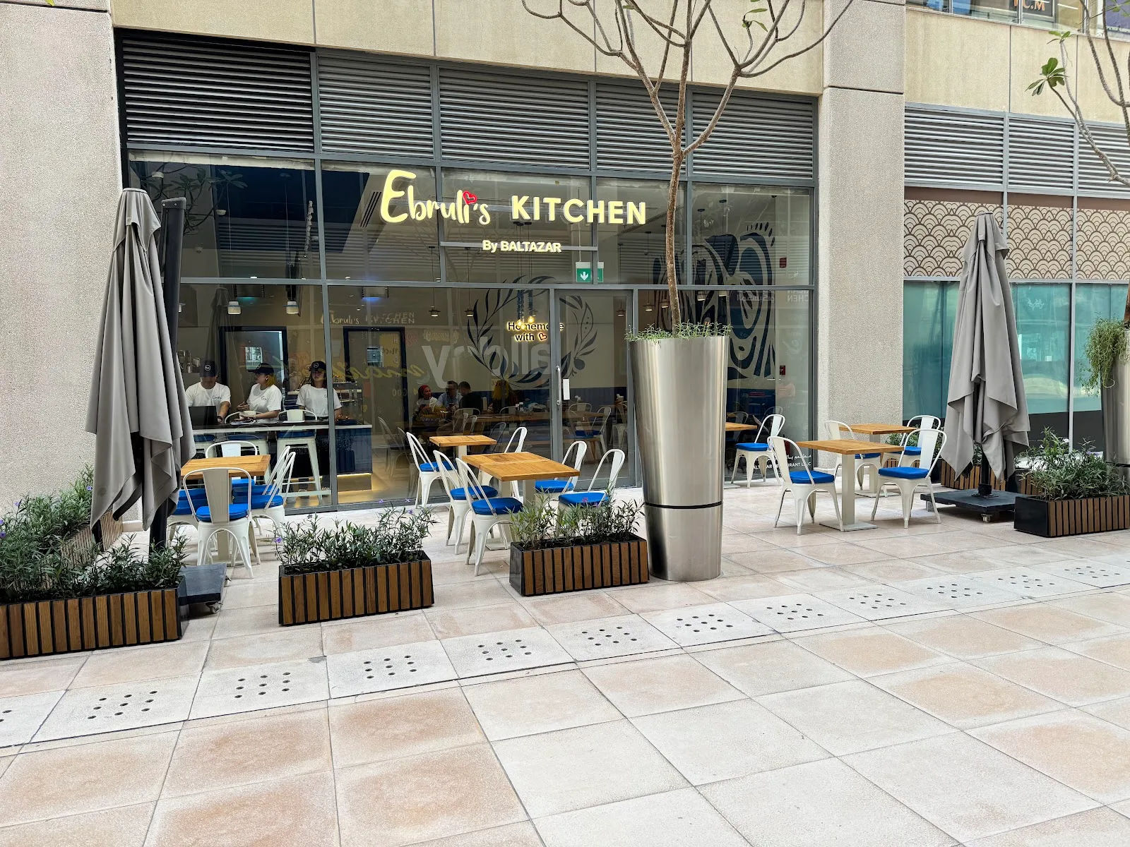 Ebruli's Kitchen storefront in Bay Square with outdoor seating