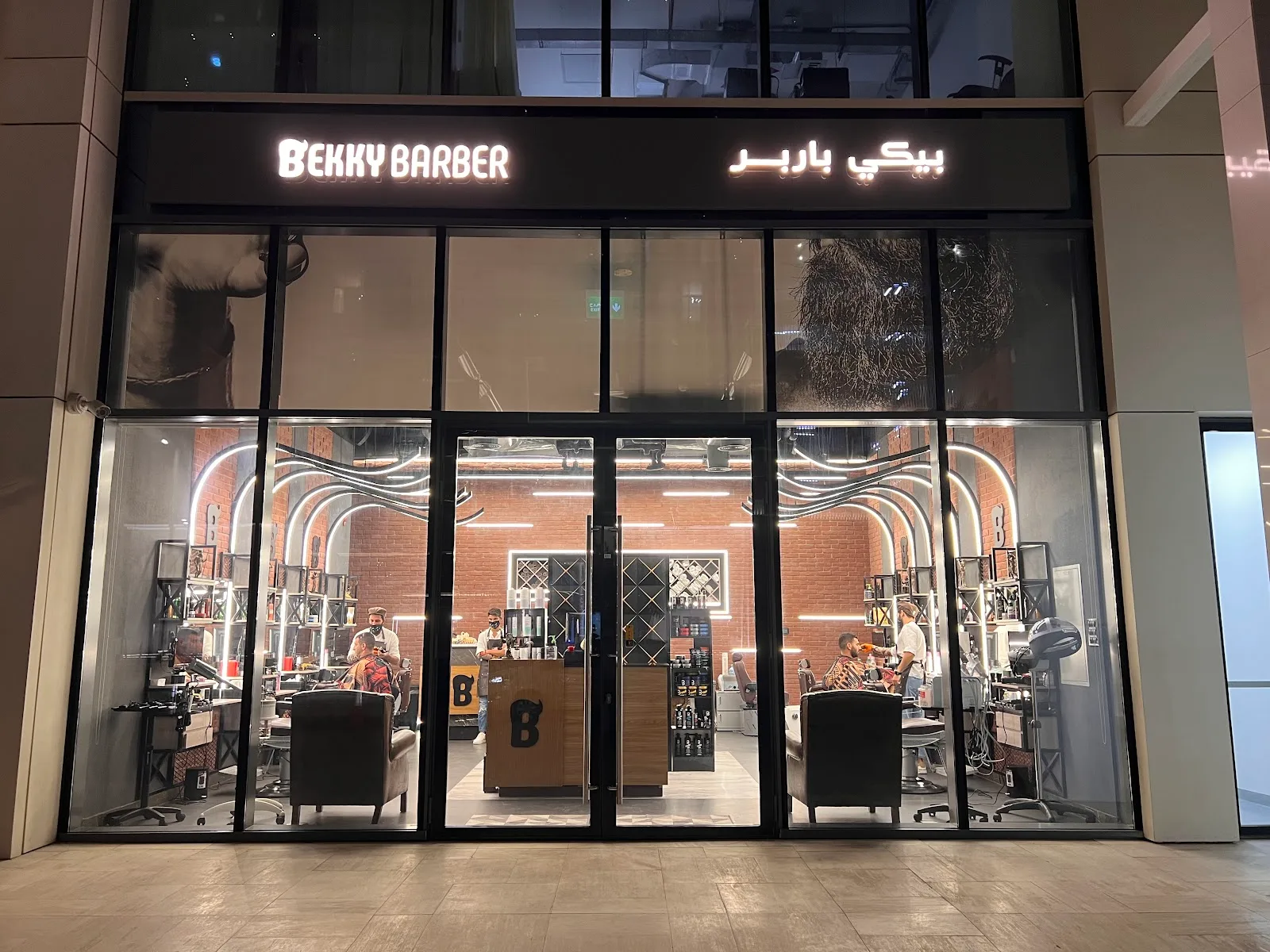 Bekky Barber Beachfront illuminated storefront at night