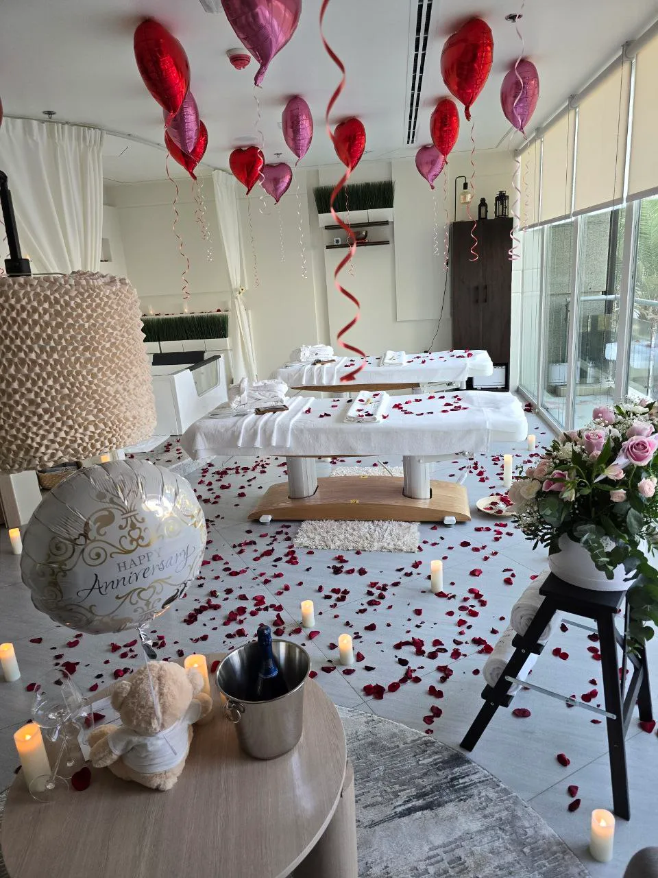 Couples spa room dressed with flowers and balloons