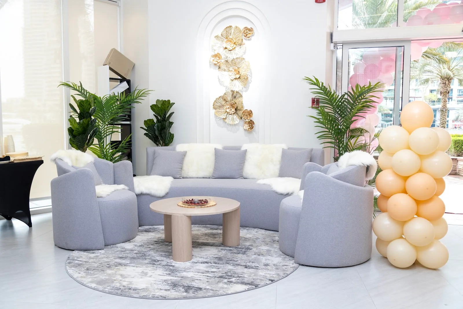 Reception lounge with sofa and gold floral wall art