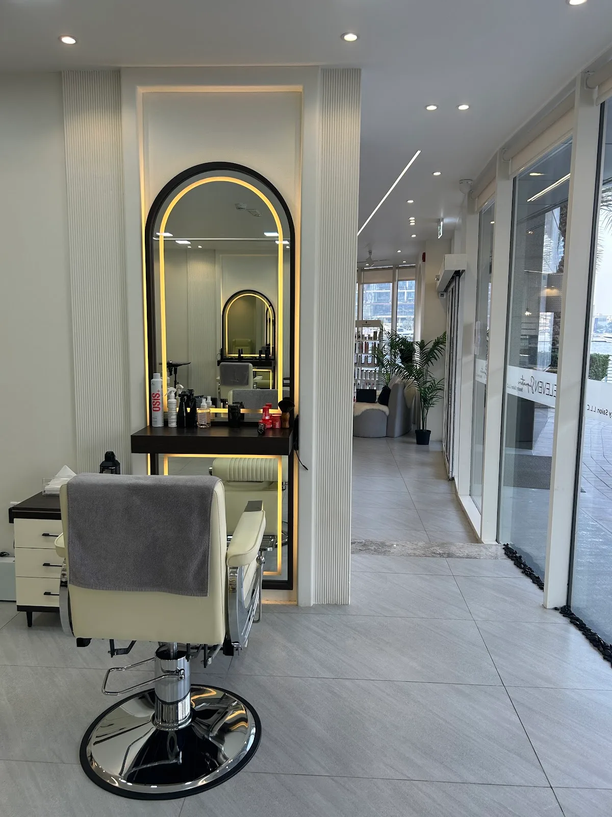 Arched mirror styling station with warm backlighting at Eleven Signature