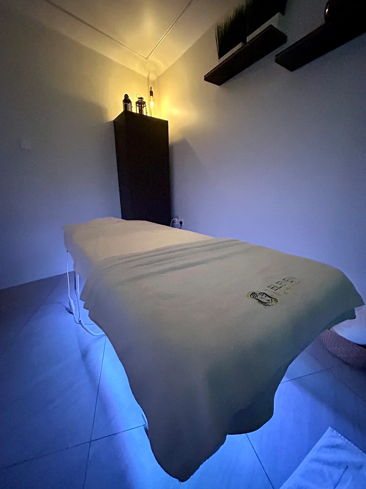 Private treatment room with soft lighting prepared for a facial