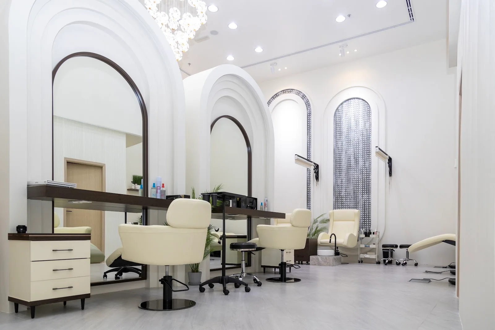 Eleven Signature styling floor with tall arched mirrors, cream chairs and a feature chandelier