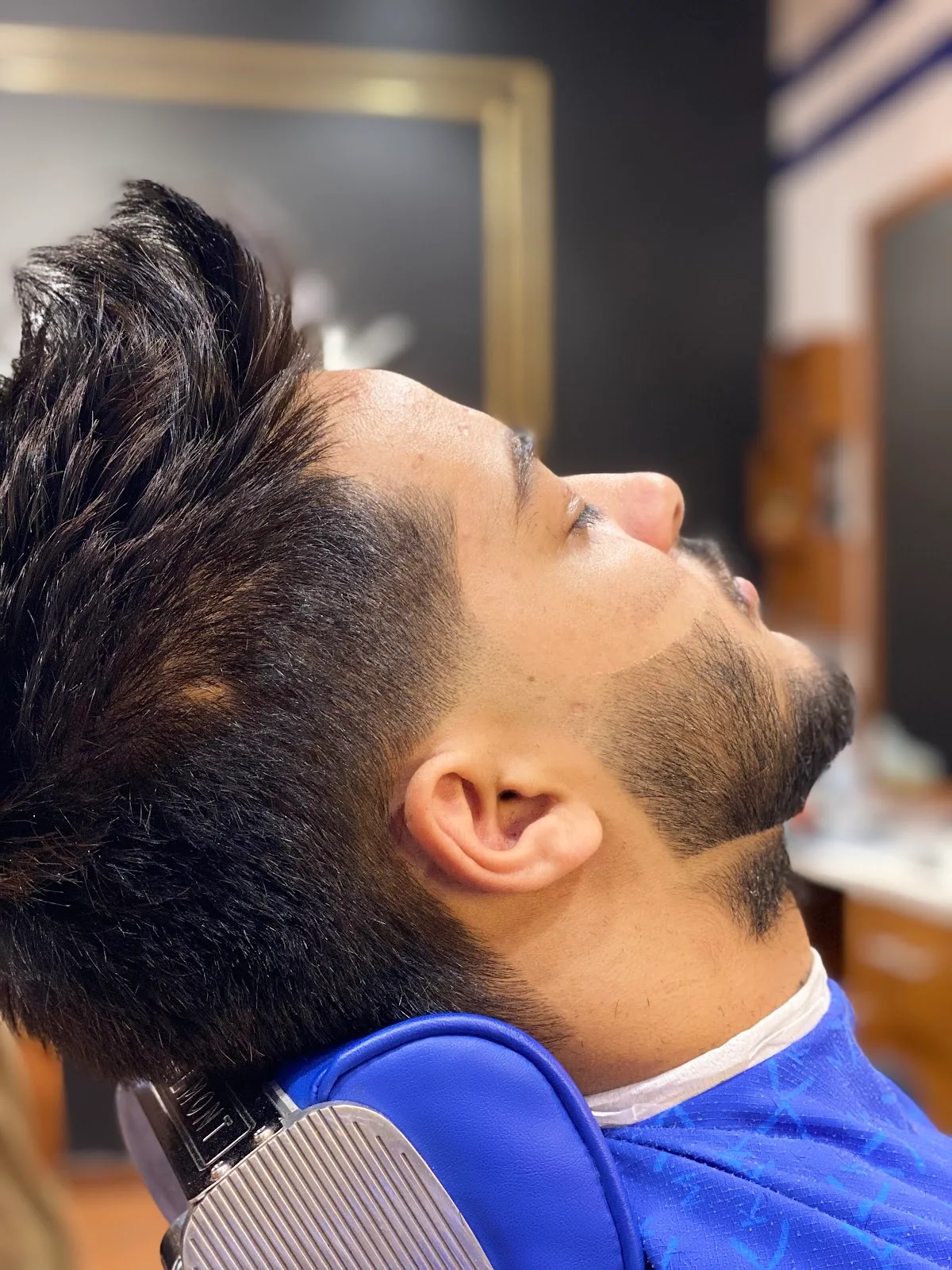 Side profile of a sharp beard fade at MK Barbershop