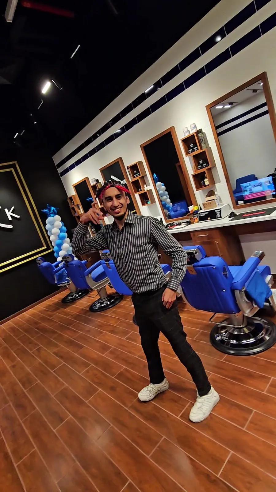 A barber in the MK Barbershop styling area