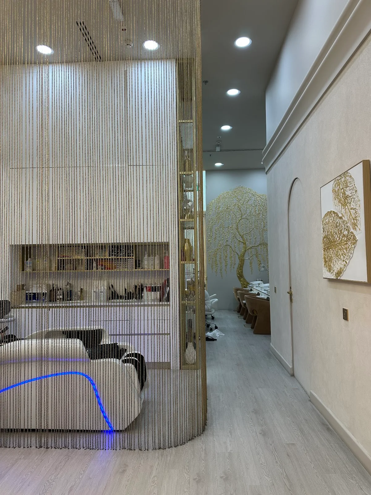 Gold chain-curtain divider leading to the nail room