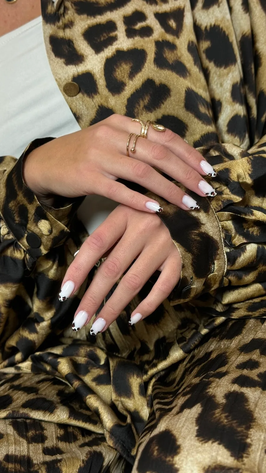 White nails with leopard-print french tips