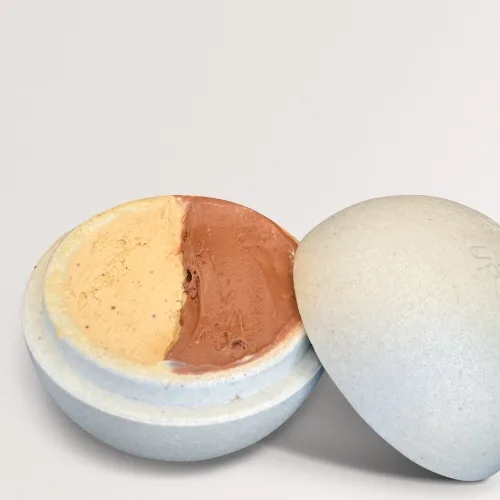A tartufo gelato sphere cut open to show pistachio and chocolate centres