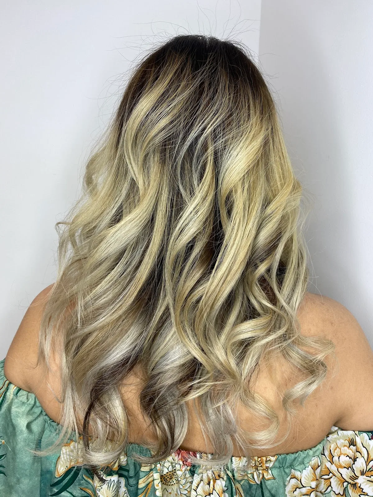 Long, glossy balayage hair styled at Mimosa Beauty Lounge