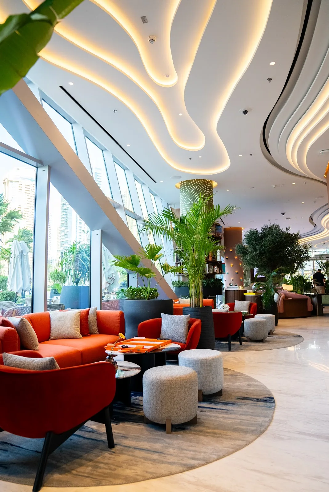 The light-filled Uptown Social lounge with terracotta seating and a sculptural ceiling