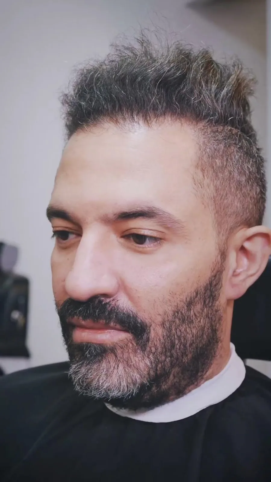 Men's facial treatment with a mask applied in a private room