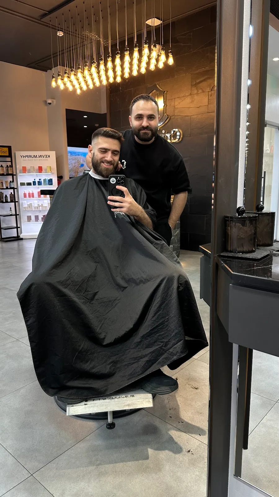 A young boy having his hair cut by a barber