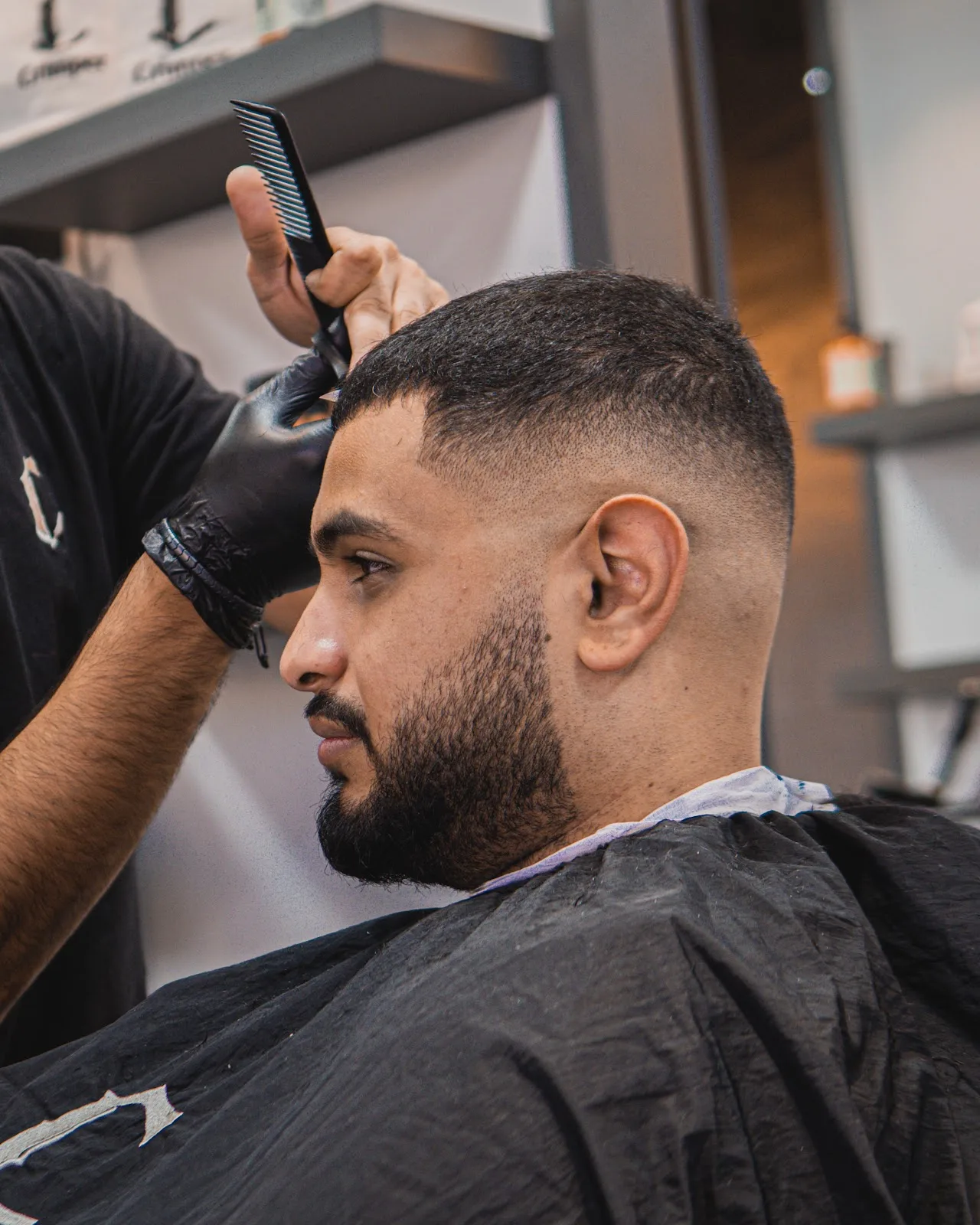 A polished barber station with a classic leather chair and mirror