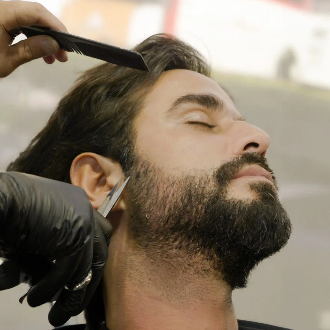 Beard being trimmed while the client reclines