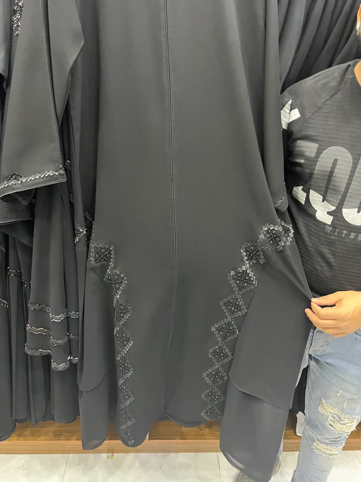 Charcoal abaya with layered hem and lace diamond trim