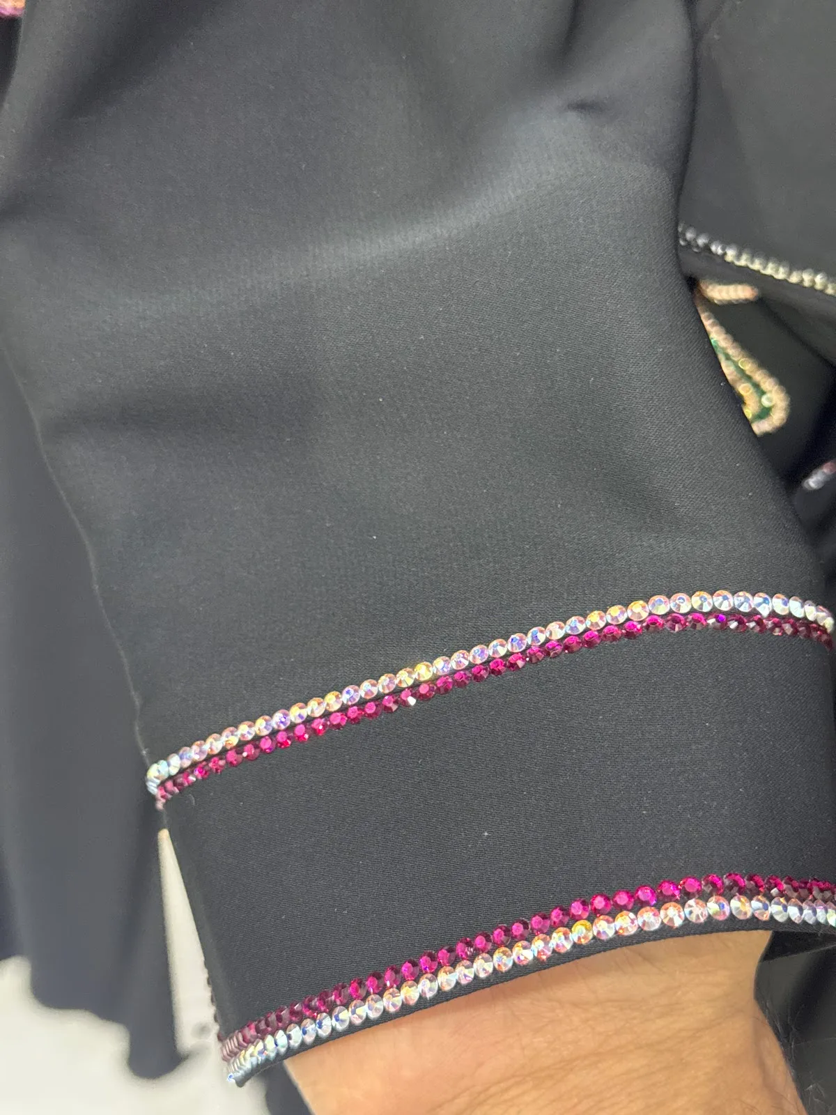 Sleeve cuff edged with rows of pink and clear crystals