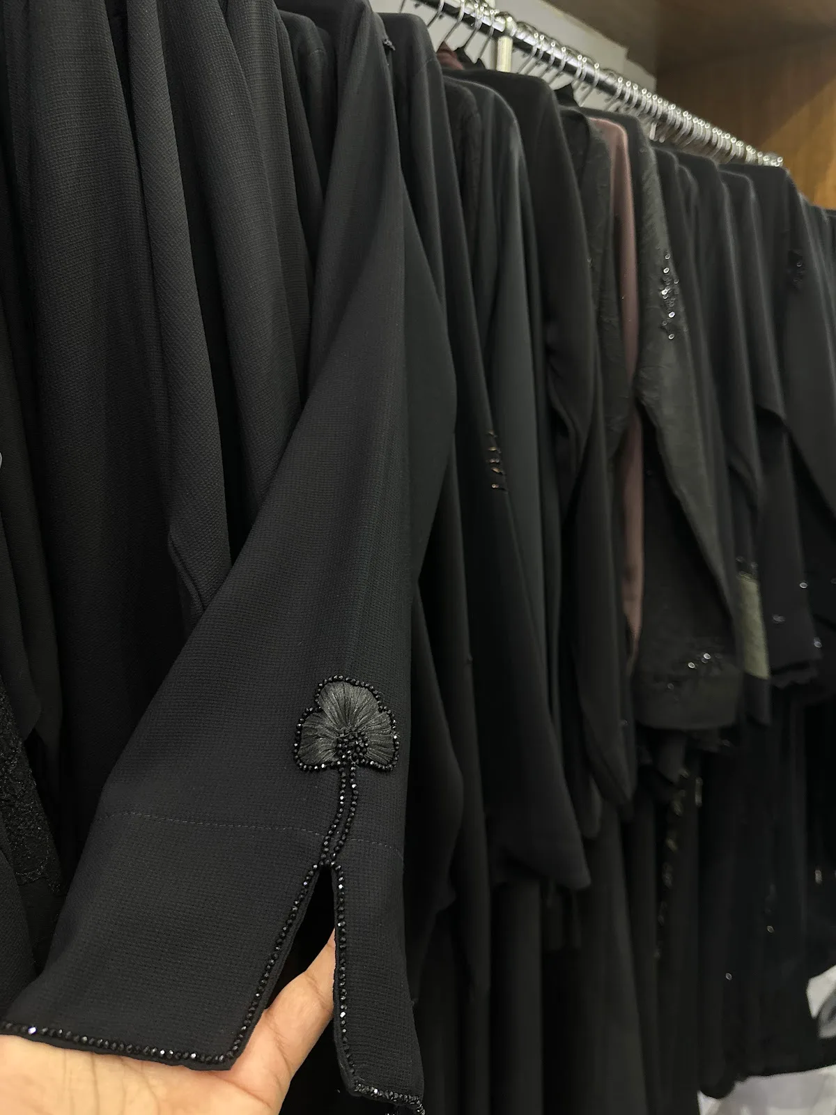 Beaded flower motif and slit detail on an abaya sleeve