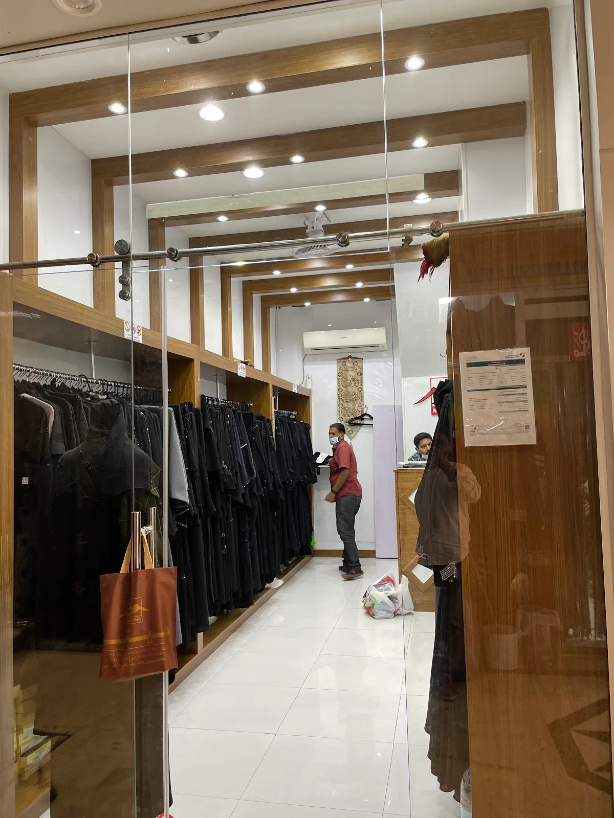 Interior corridor of the Maitha shop lined with abayas