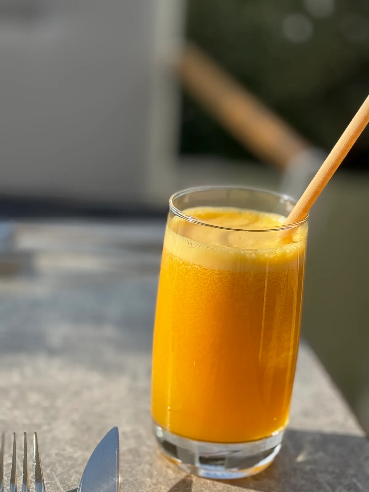 A glass of fresh orange juice in the sun