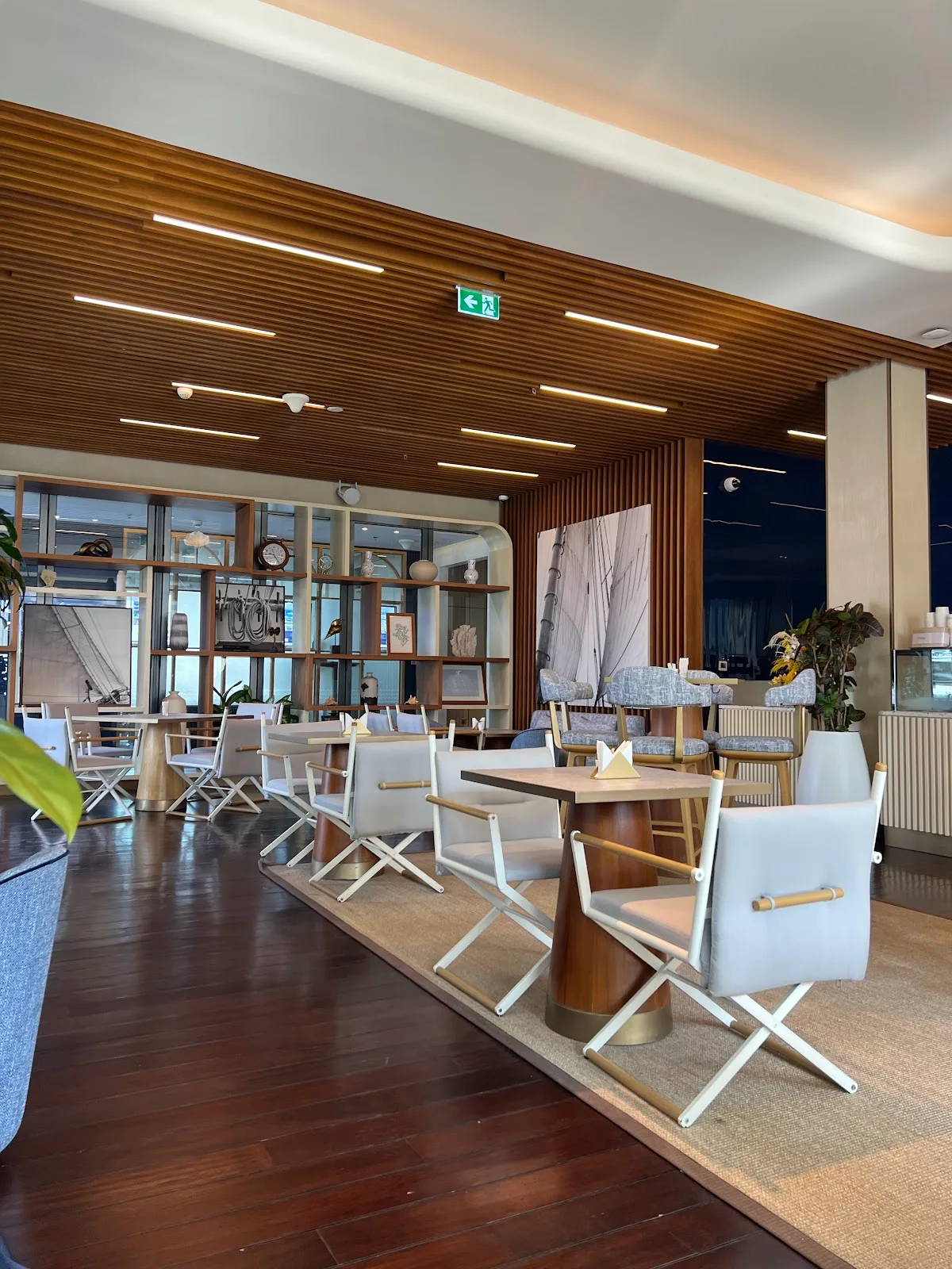 The dining room with director's chairs and warm wood ceiling