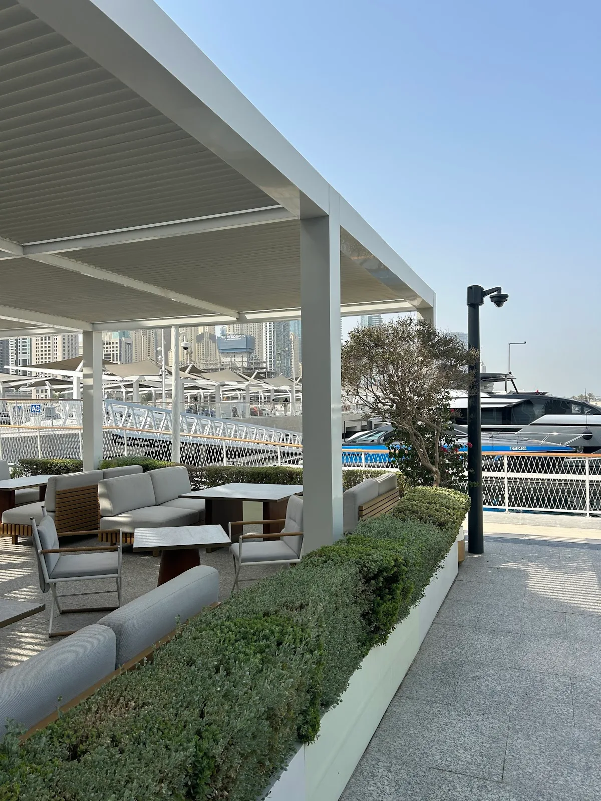 The covered terrace looking over moored yachts in the marina