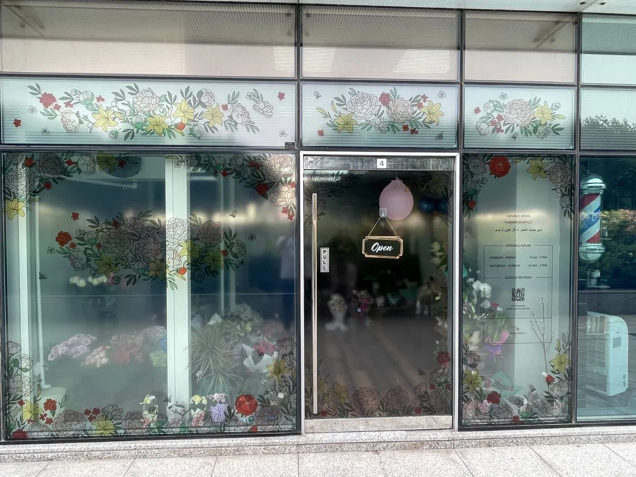 The Double Jenya Flower Shop storefront with floral window artwork