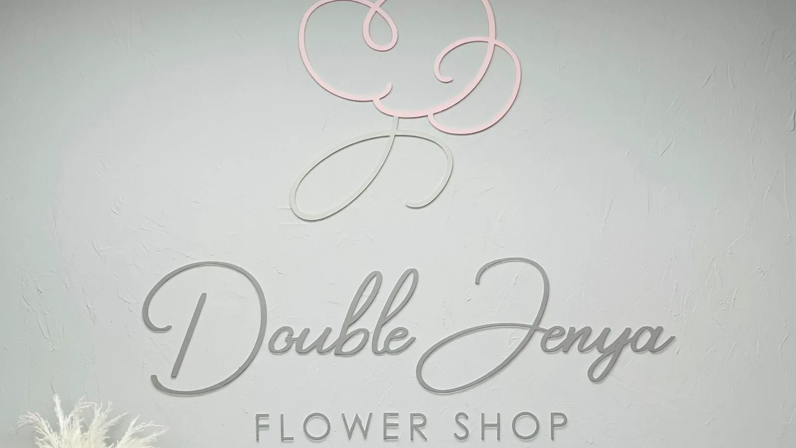 The Double Jenya Flower Shop name and emblem on the studio wall