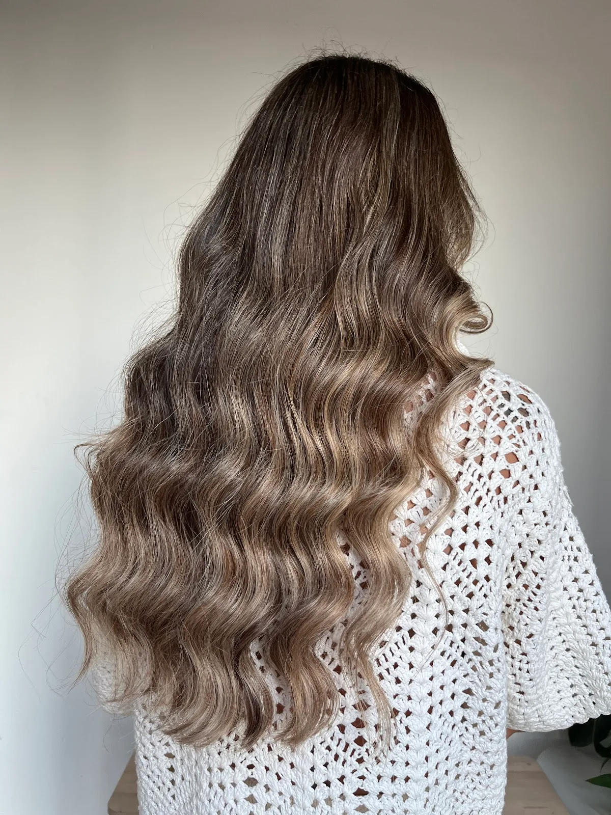 Long, softly waved brunette hair styled at the studio