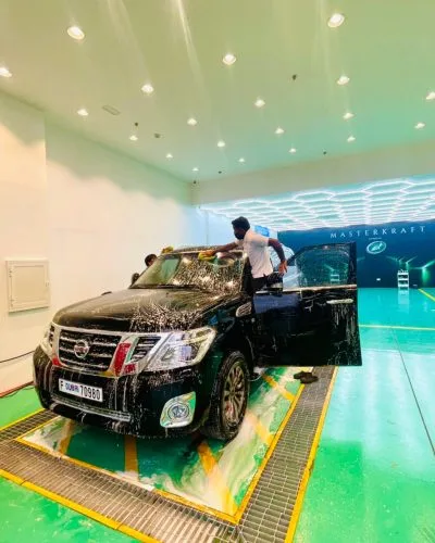 Large black SUV being washed in the studio
