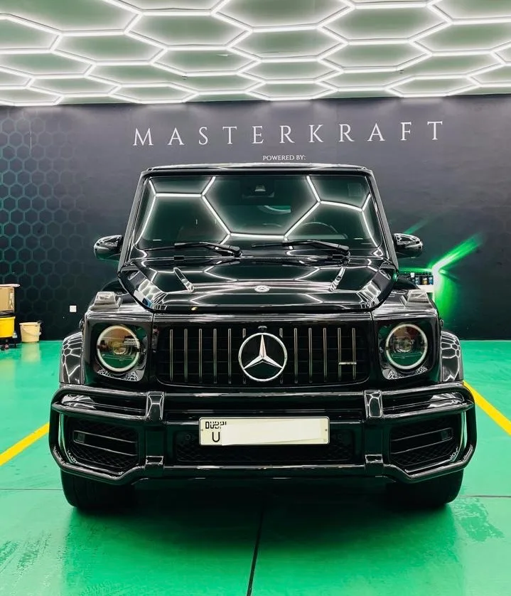 Black SUV detailed at MasterKraft, reflecting the studio's hexagon ceiling lights