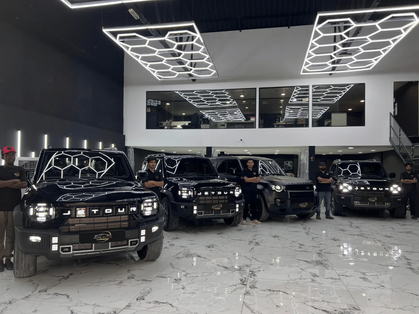 Elite Crystal Car Care showroom lined with luxury vehicles