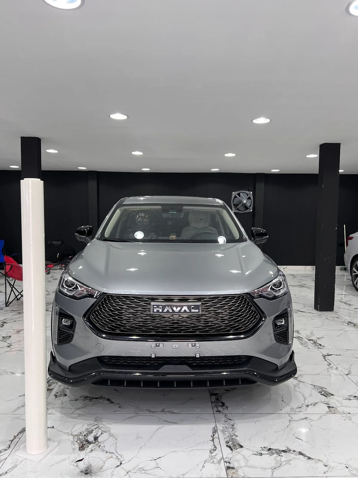 Grey SUV prepped inside the protective detailing bay