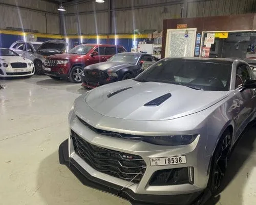 Silver Chevrolet Camaro ZL1 parked inside the garage